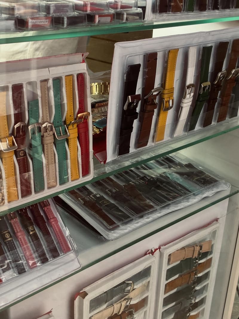Vitrine com pulseiras de couro para relógio em várias cores: amarelo, verde, vermelho, marrom e preto